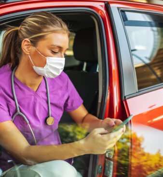 nurse using her phone in the car
